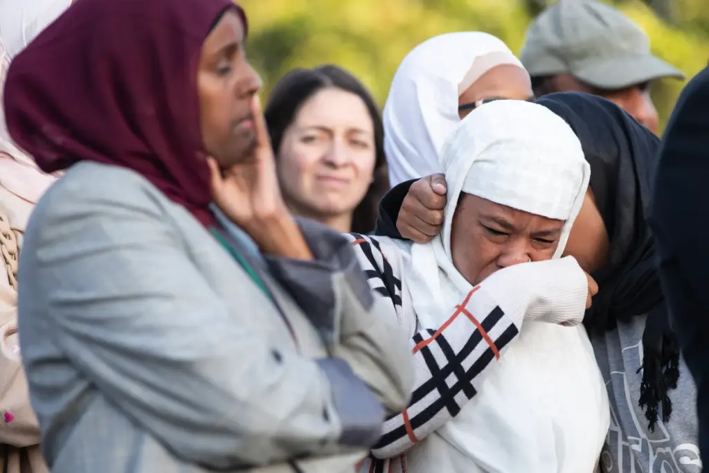 San Diego, CA – People react to speakers during an...
