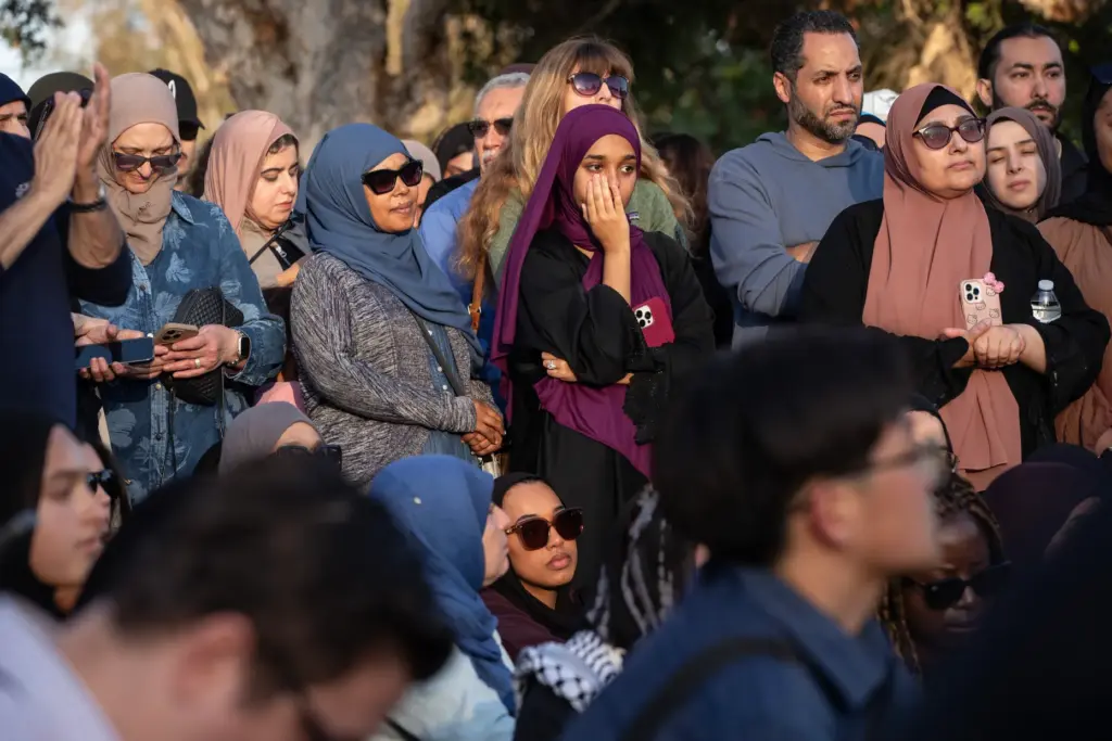 San Diego, CA – People react to speakers during an...