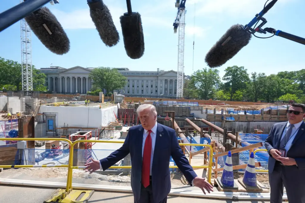 President Donald Trump tours ballroom construction around the outside the White House.