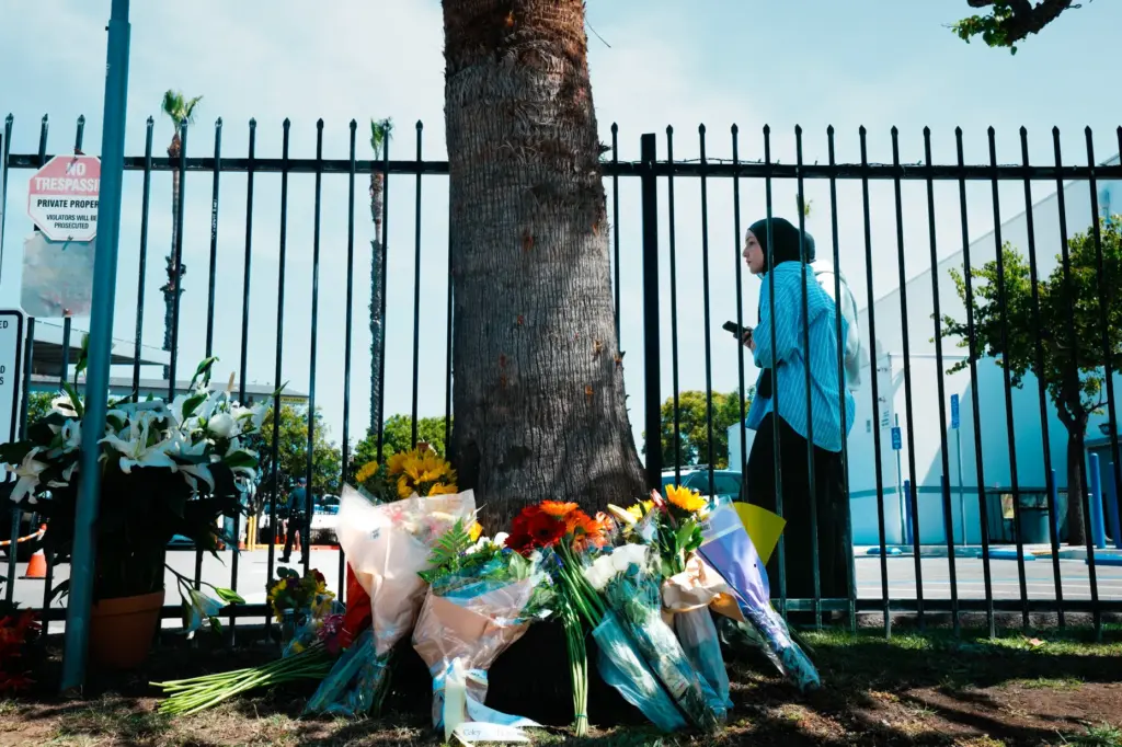 Throughout the day, members and the public placed bouquets of...