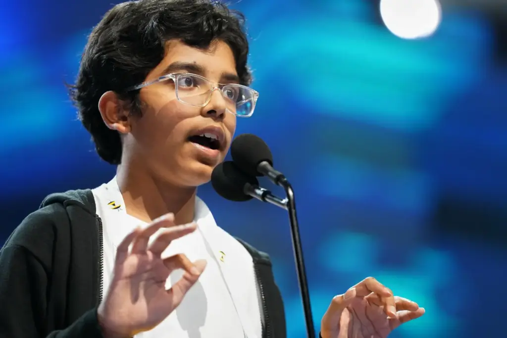 Sarv Dharavane spells his word during the final round of the 2026 Scripps National Spelling Bee.