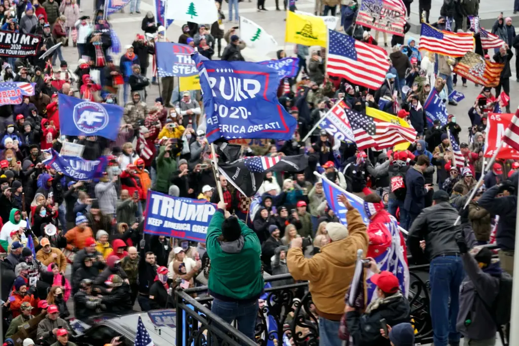 FILE – Violent protesters gather outside the U.S. Capitol, Jan...