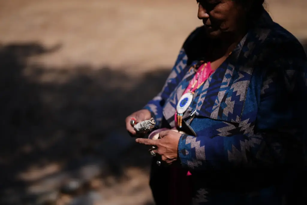 Norma Meza Calles, a Kumeyaay Nation leader, lights a bundle of white sag