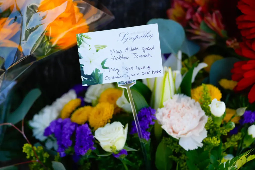 Throughout the day, members and the public placed bouquets of...