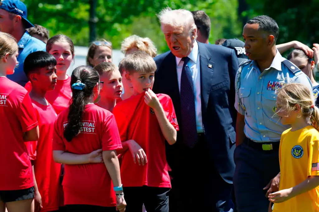 President Donald Trump walks with kids during exercise drills