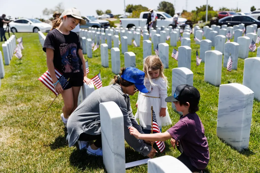 Courtney Sanford helps her children Noelle, 11; Aubrey, 3, and...