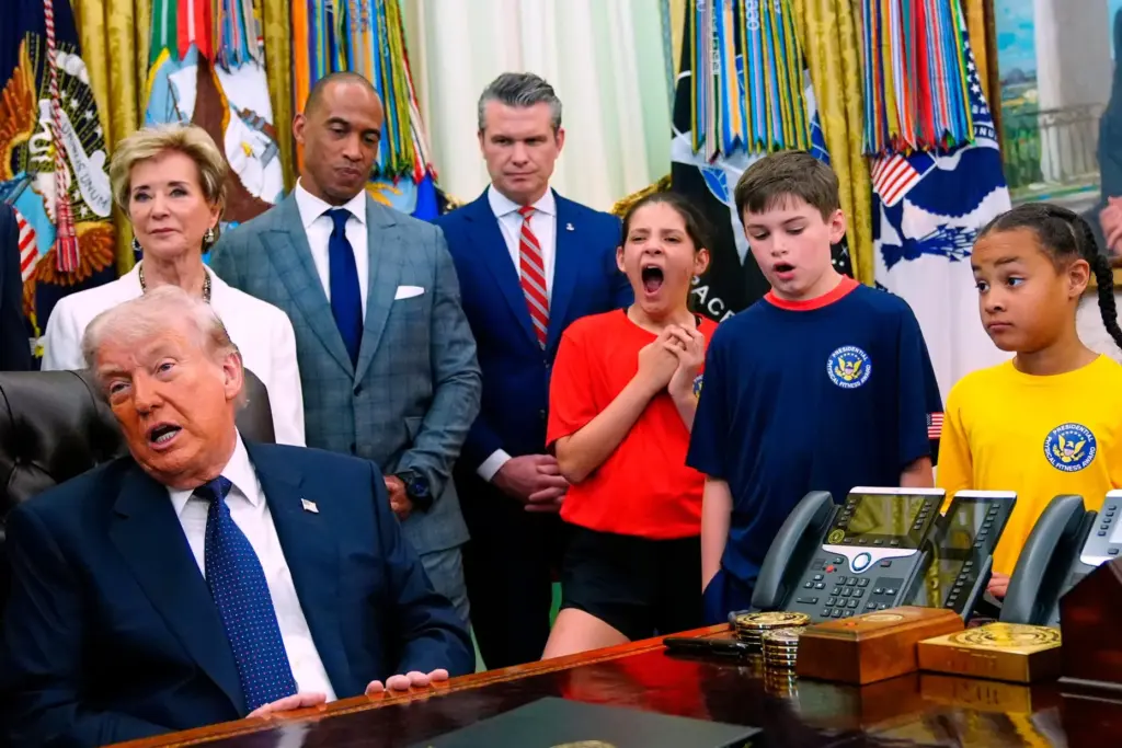 a child yawns as Donald Trump speaks in the oval office