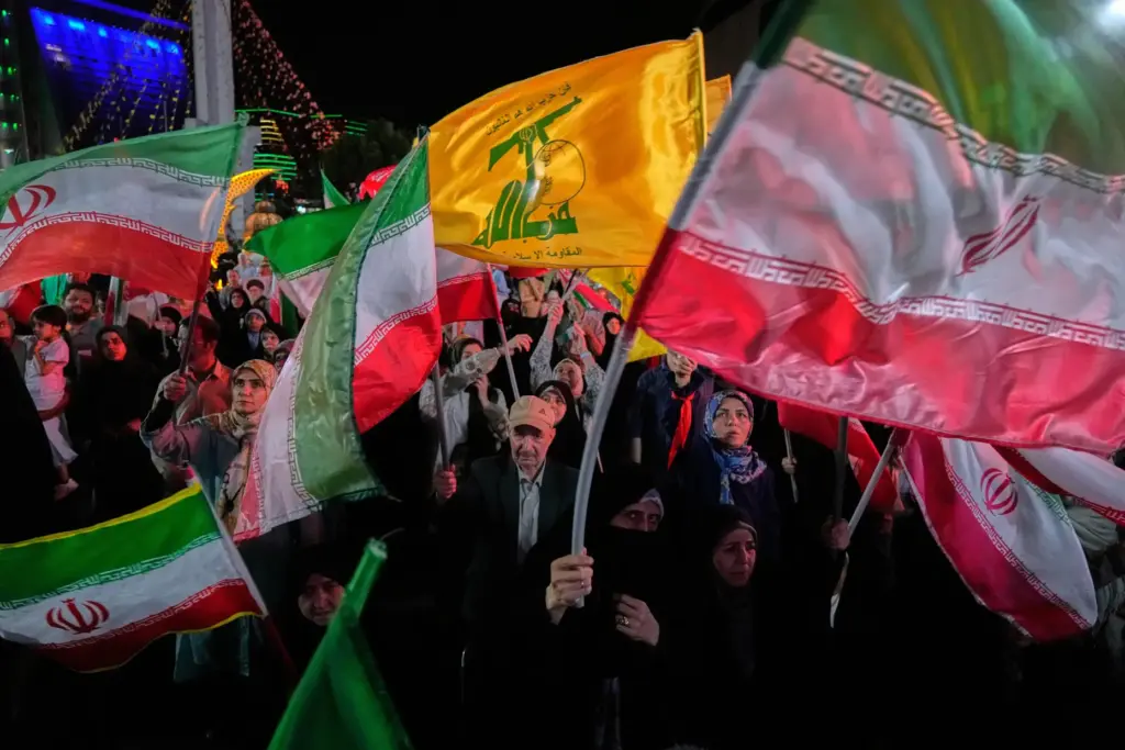 Iranian demonstrators wave their country's flags and Lebanon's militant Hezbollah group flags.