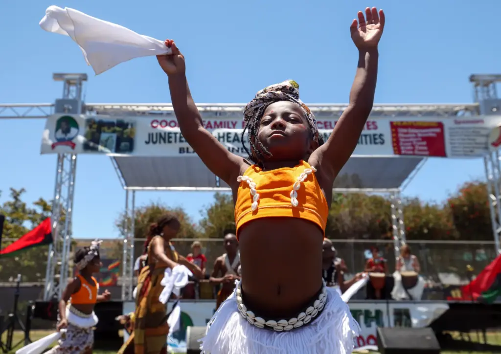 Stella Antoine, 5, performs with other children with the West...
