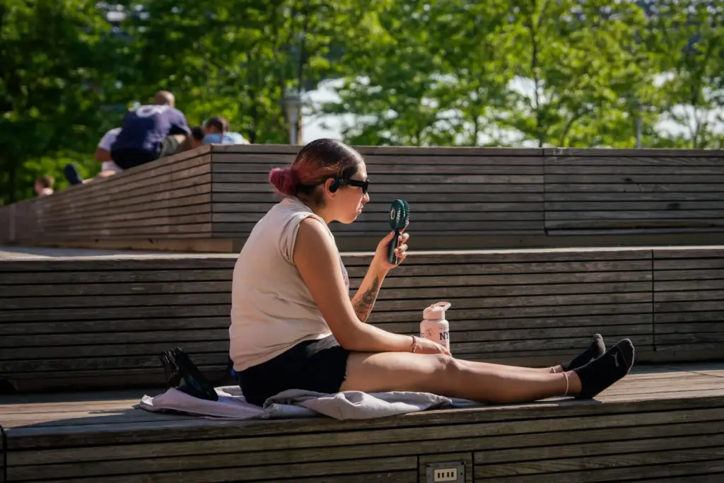 A person uses a fan during a heat advisory in Brooklyn.