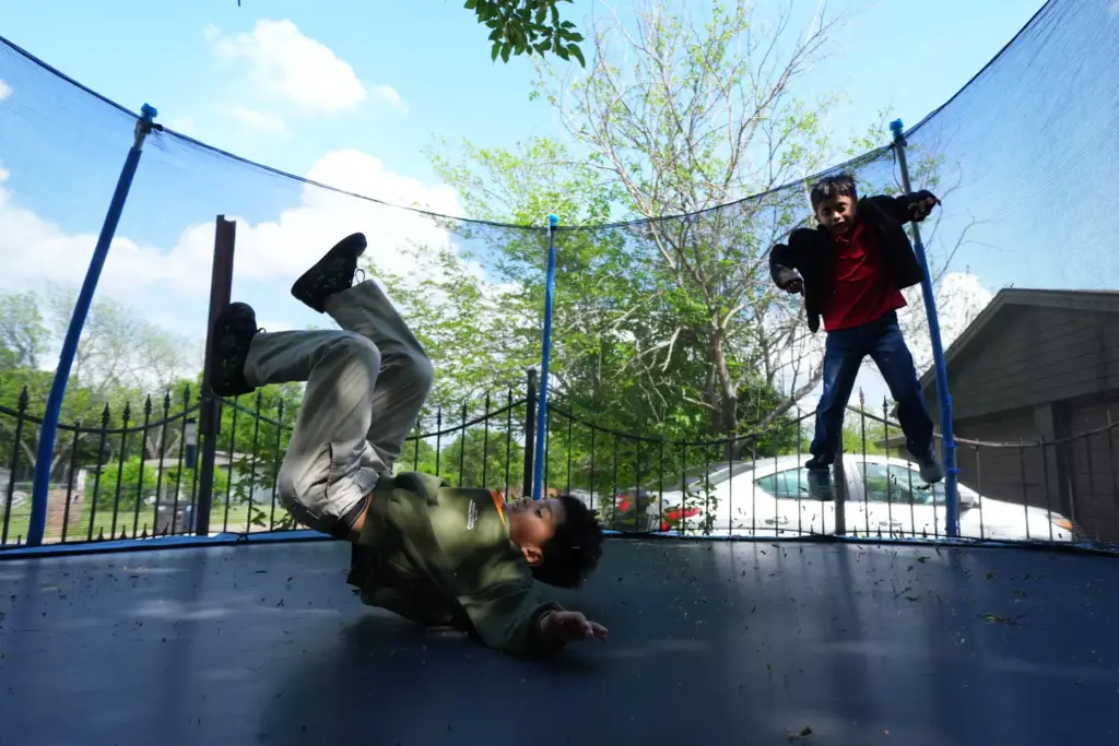 Ian Contreras, right, jumps on a trampoline with Jose Gonzalez...