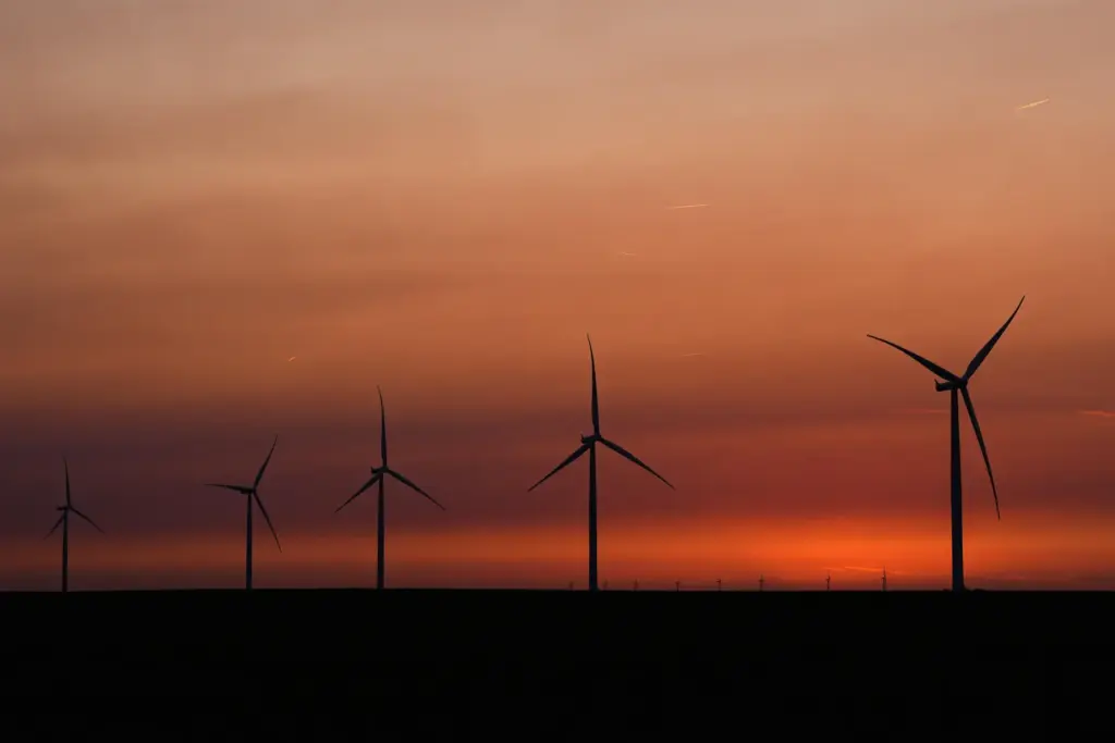 FILE – Wind turbines are silhouetted against the sky at...