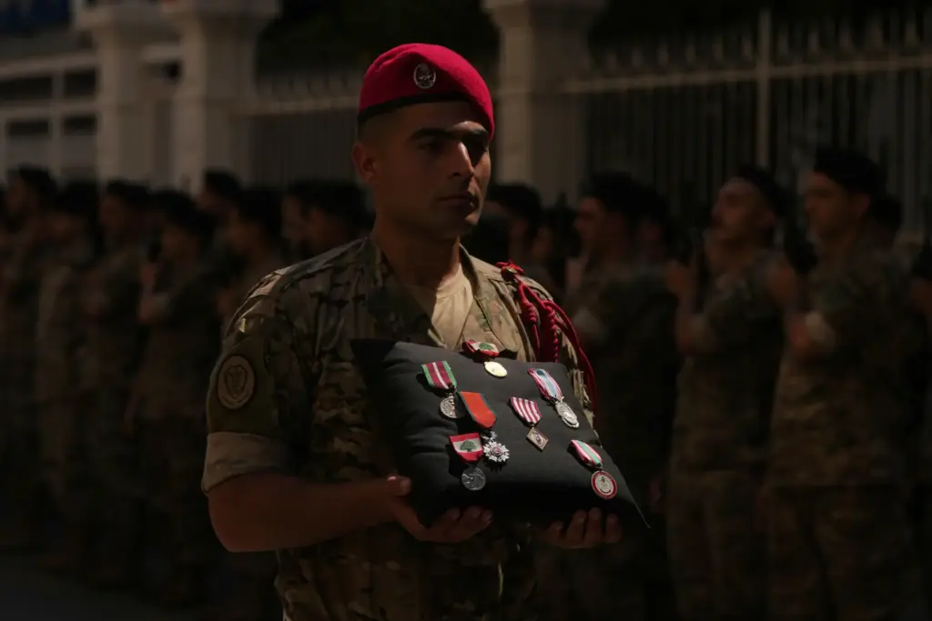 A Lebanese Army soldier carries the medals of Lebanese Brig. Gen. Wissam Sabra.