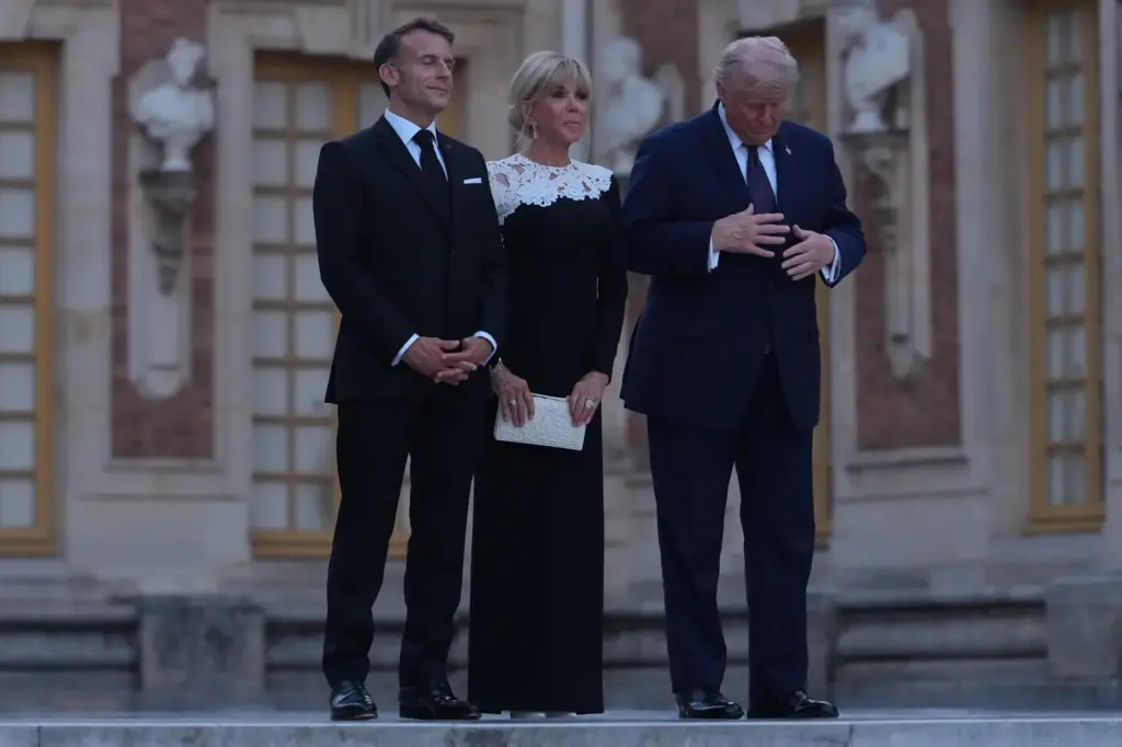 U.S. President Donald Trump is greeted by French President Emmanuel...