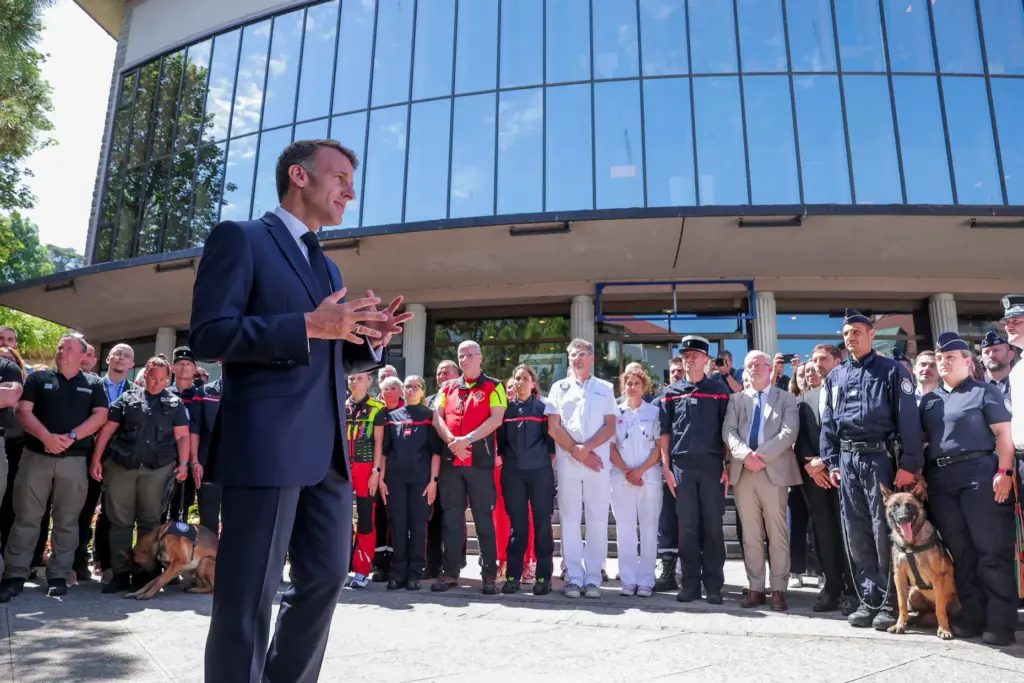 French President Emmanuel Macron meets members of the emergency forces.