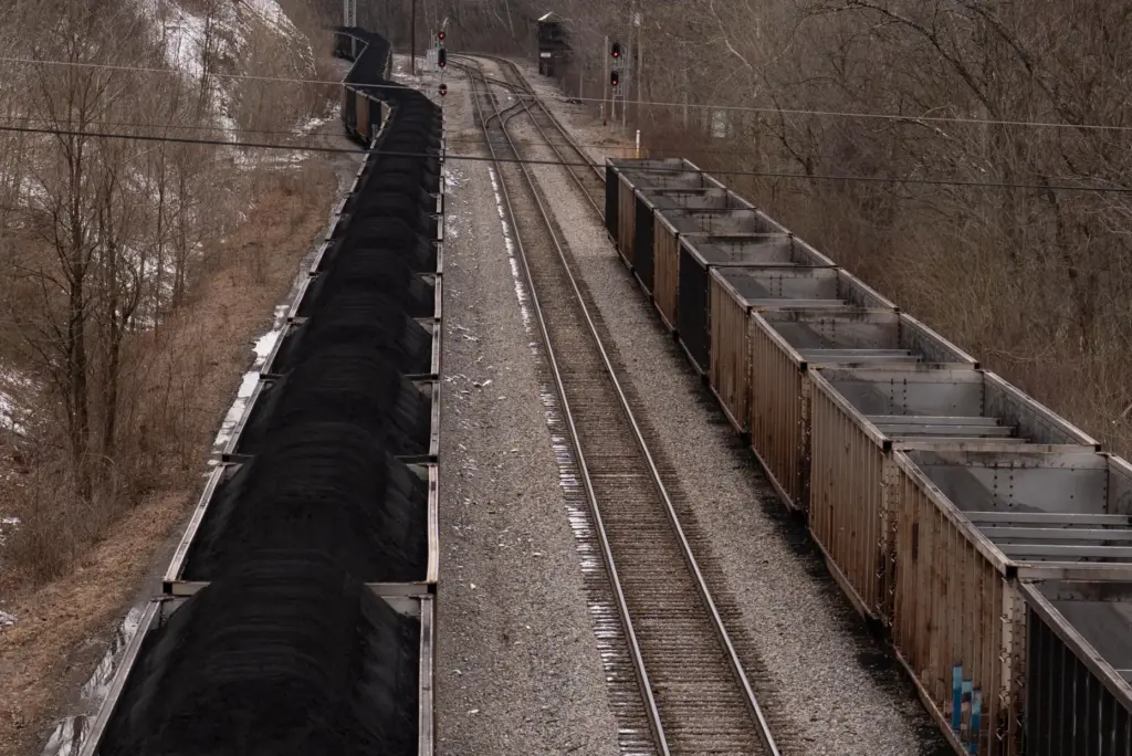 FILE – A train with coal pauses on the tracks...
