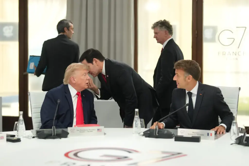Secretary of State Marco Rubio speaks with President Donald Trump during the G7 summit.