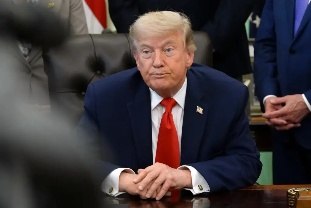President Donald Trump listens during an event in the Oval Office.