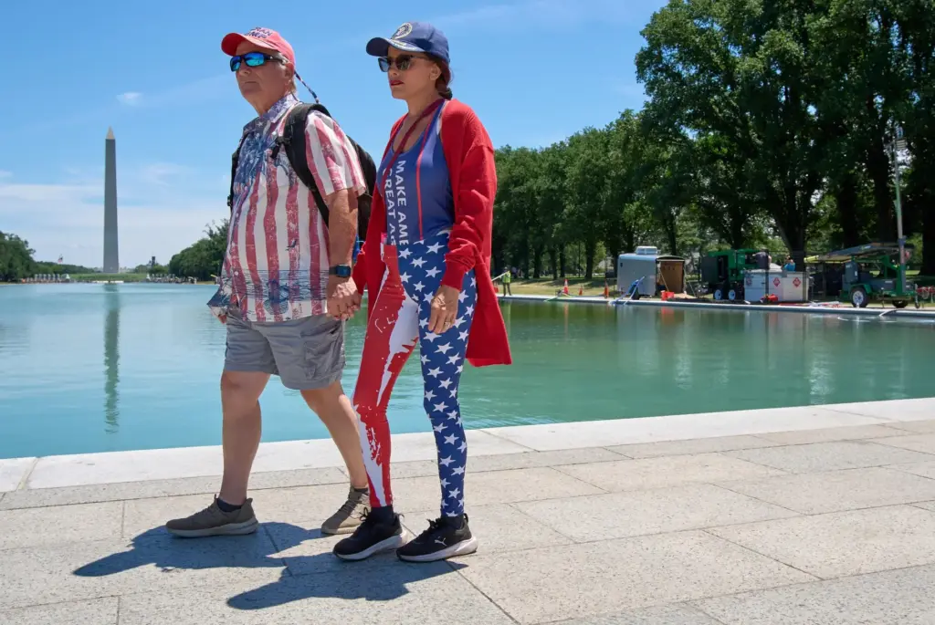 Rick and Ariana Pettit of Las Vegas, walk past the...