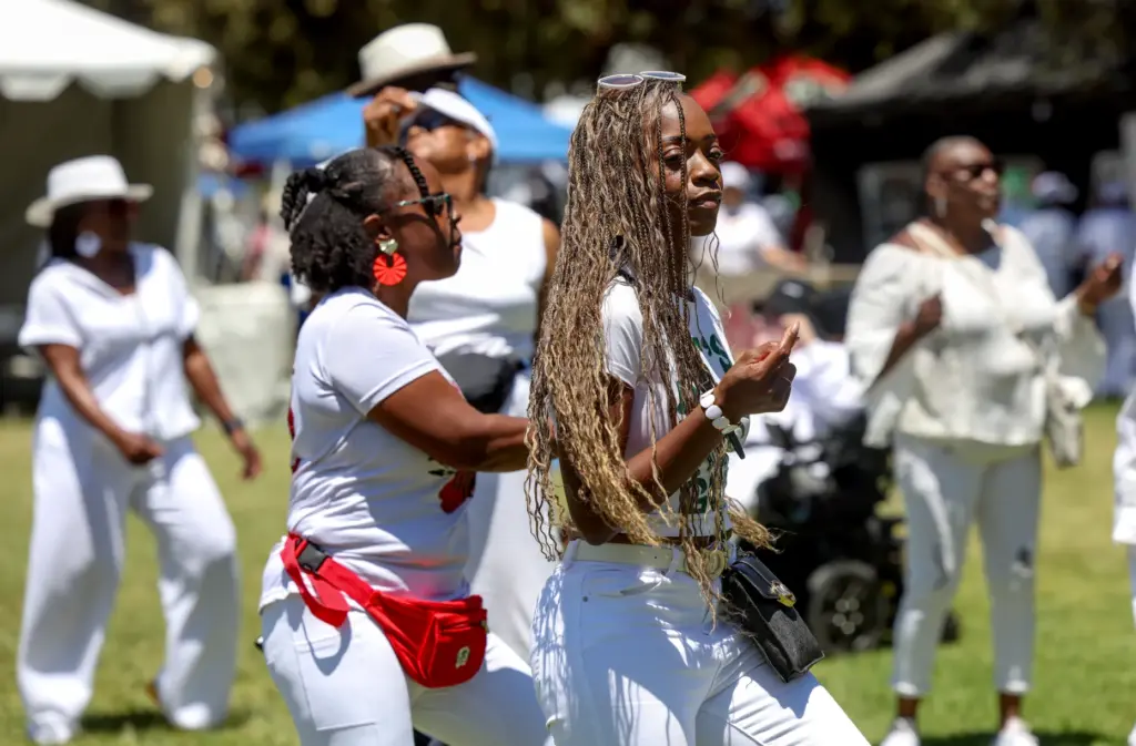 Serenity Baldon, front, and others dance to the music during...