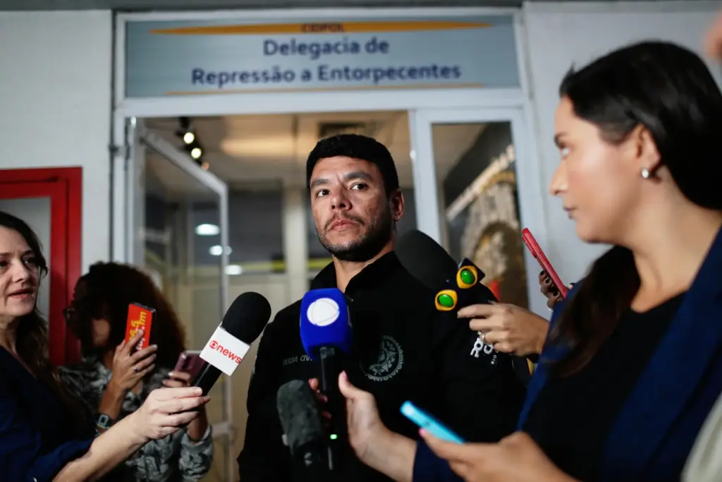 Police officer Moyses Santana speaks with the press about the...