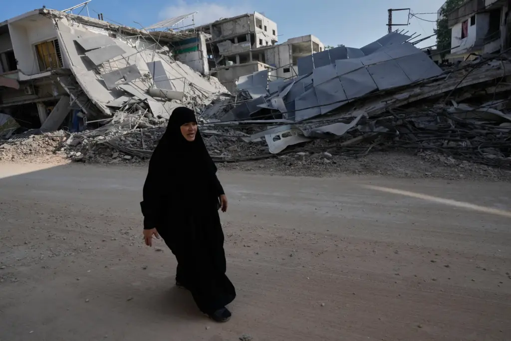 A woman returns to her village following the announcement of...