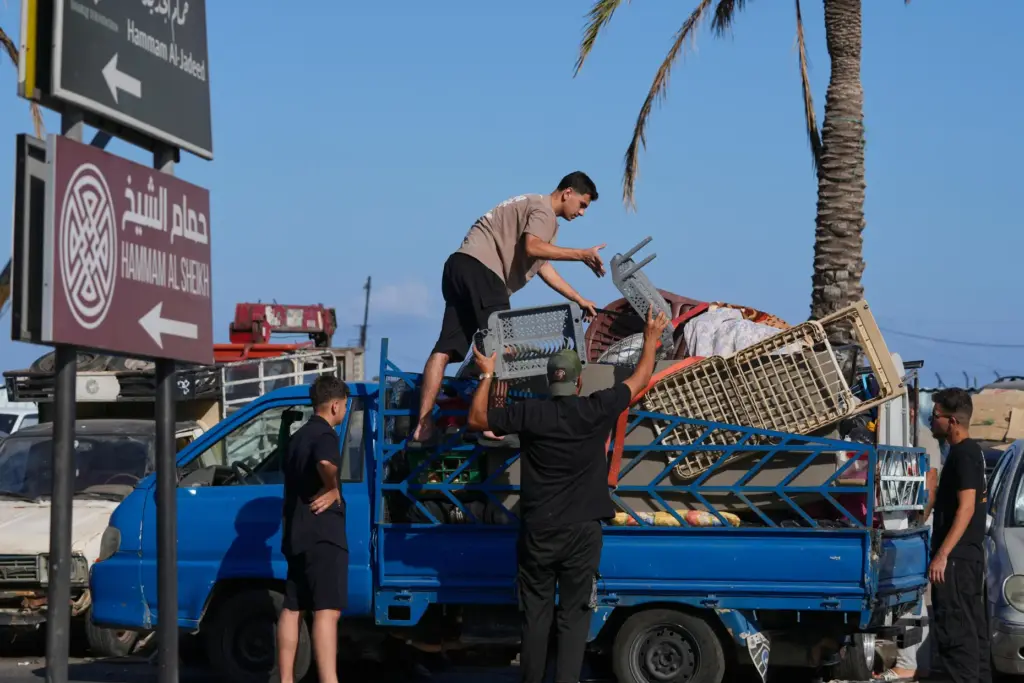Displaced people pack their belongings as they prepare to return to their village in Lebanon.