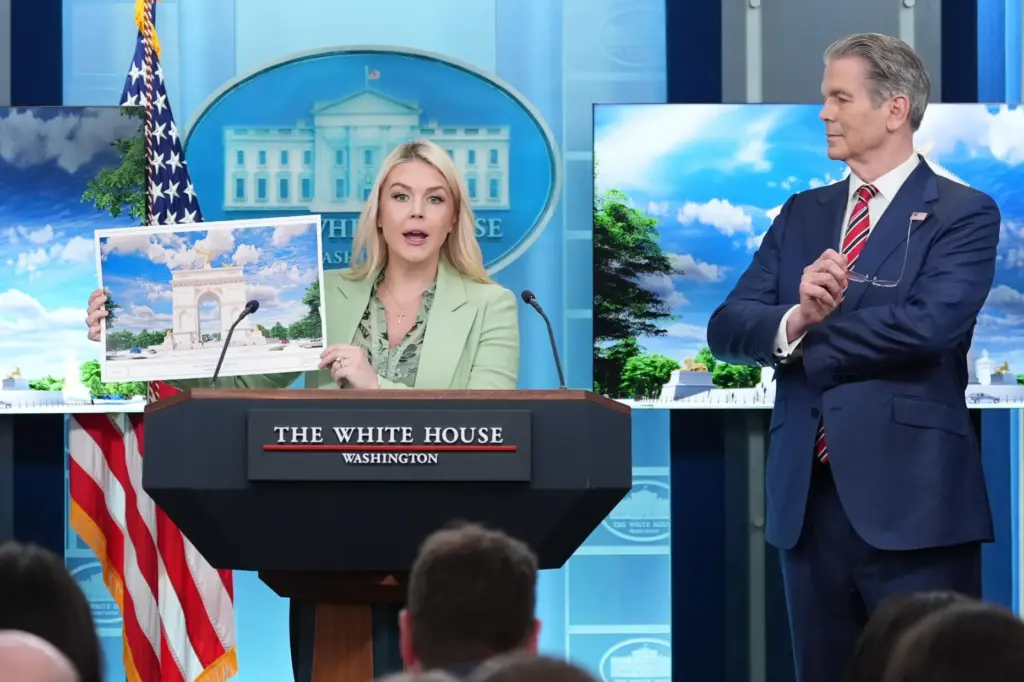 FILE – White House press secretary Karoline Leavitt holds up...