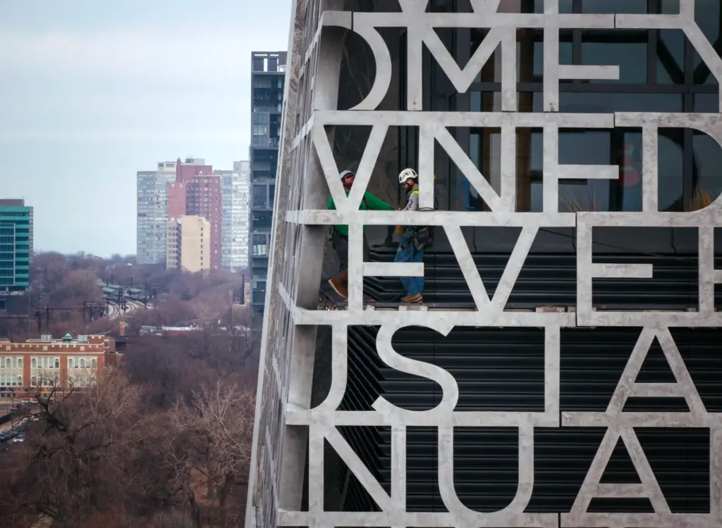 Workers finish installing words from from President Barack Obamaâs speech...
