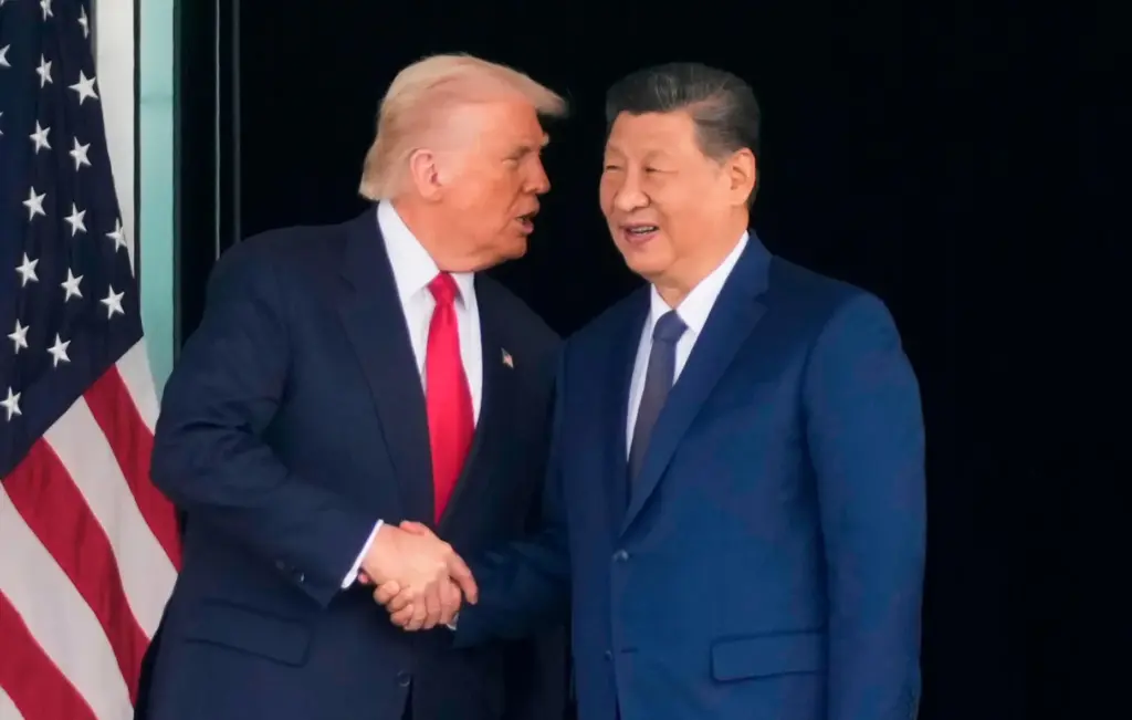 President Donald Trump and Chinese President Xi Jinping shake hands.