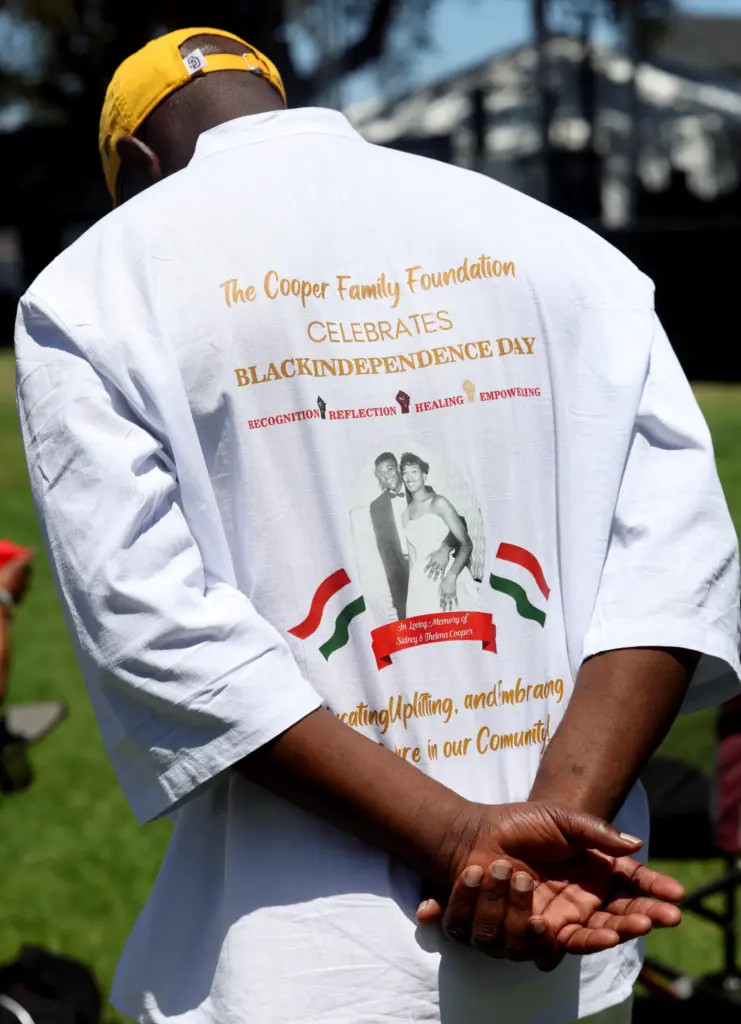Sydney Cooper Jr. wears a shirt with a picture of...