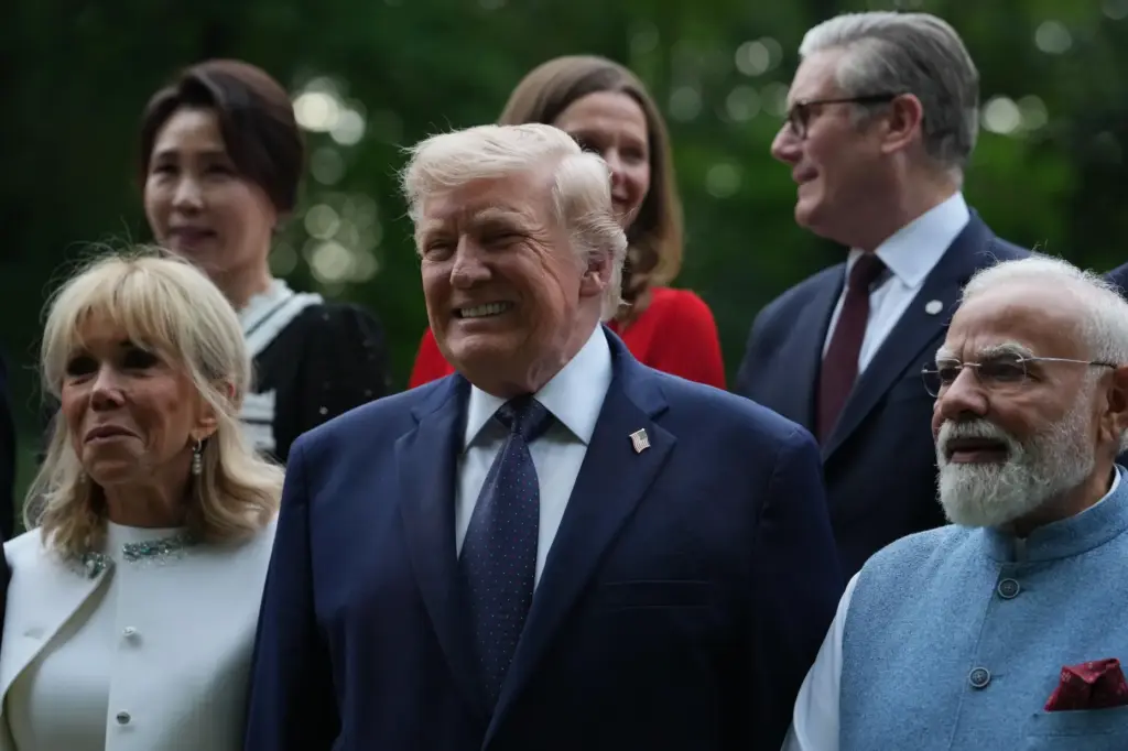 U.S. President Donald Trump poses with and first lady Brigitte...