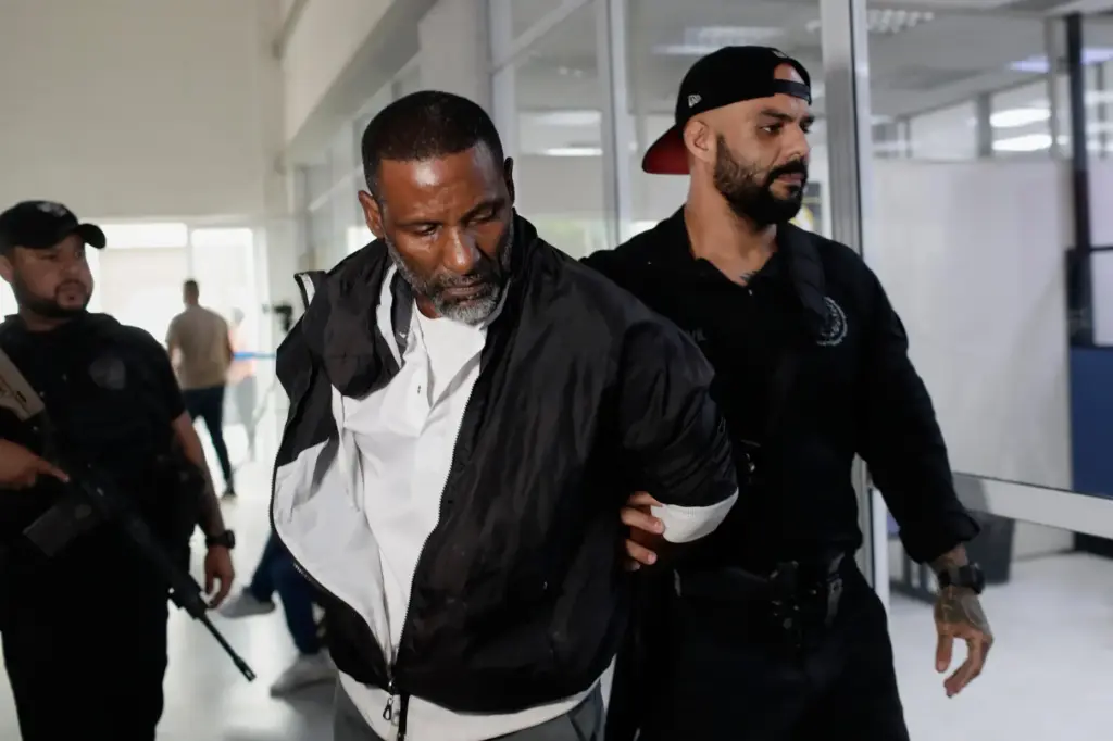A suspected member of the criminal group Comando Vermelho, or...
