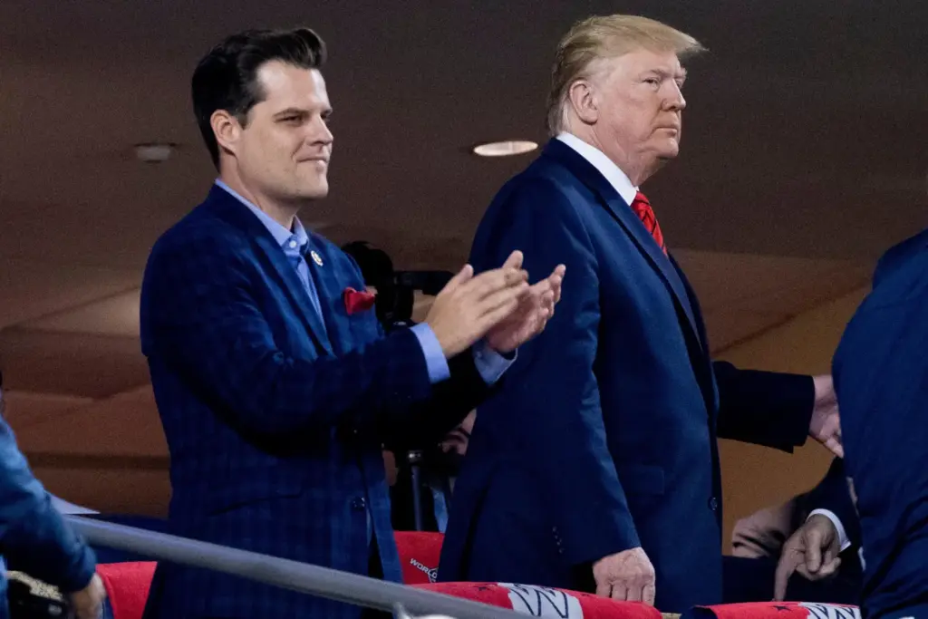 FILE – President Donald Trump, right, accompanied by Rep. Matt...
