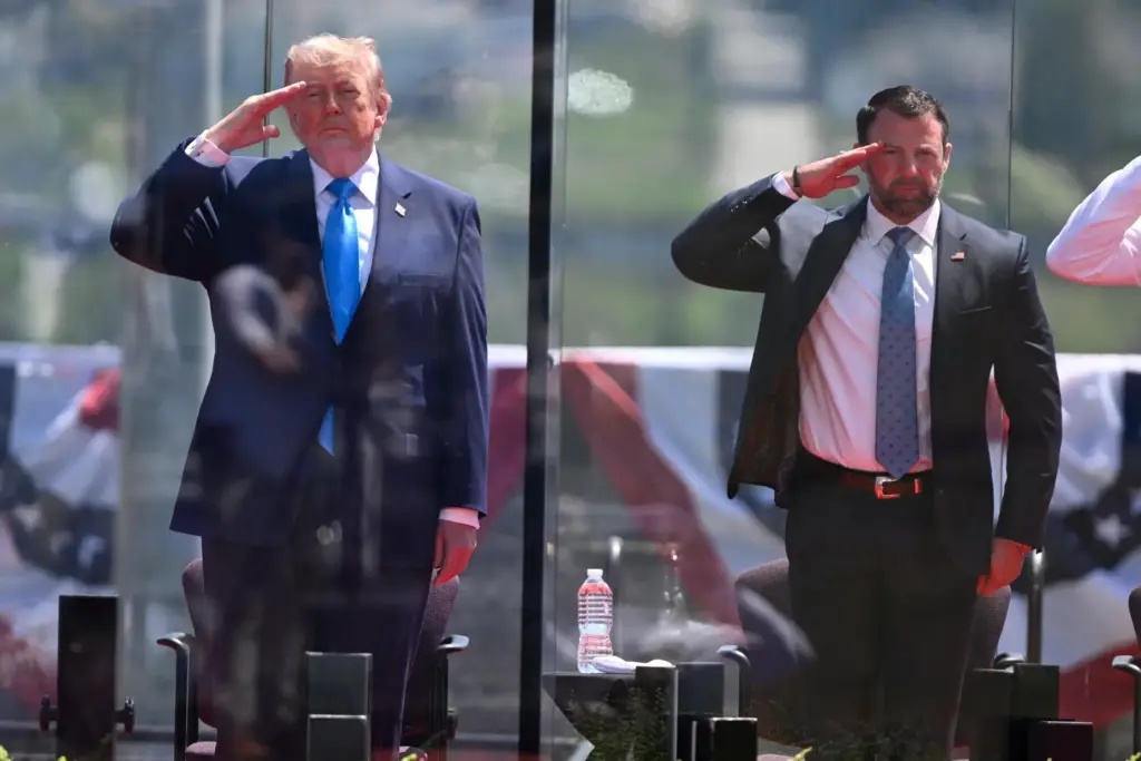 President Donald Trump and Secretary of Homeland Security Markwayne Mullin salute.