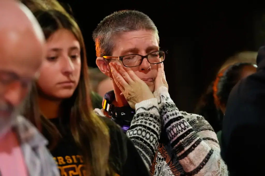 An attendee reacts at a candlelight vigil where a Madison police officer killed a man.