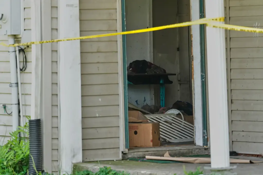 Items are seen beyond police tape in a home where...