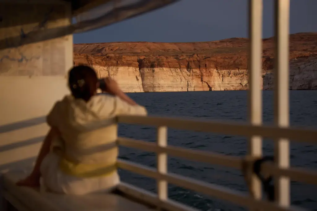 A person takes a picture during a tour on Lake Powell.