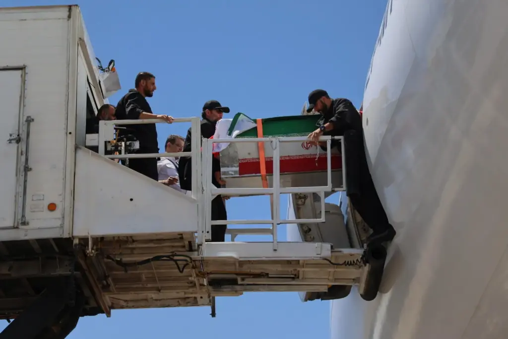 The coffin of Iranian Supreme Leader Ayatollah Ali Khamenei is carried from a plane.
