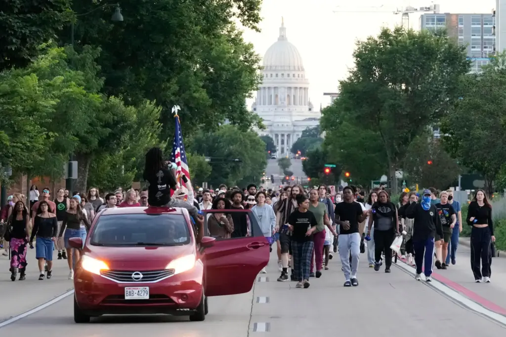 Protesters march after a Madison police officer shot and killed a man.