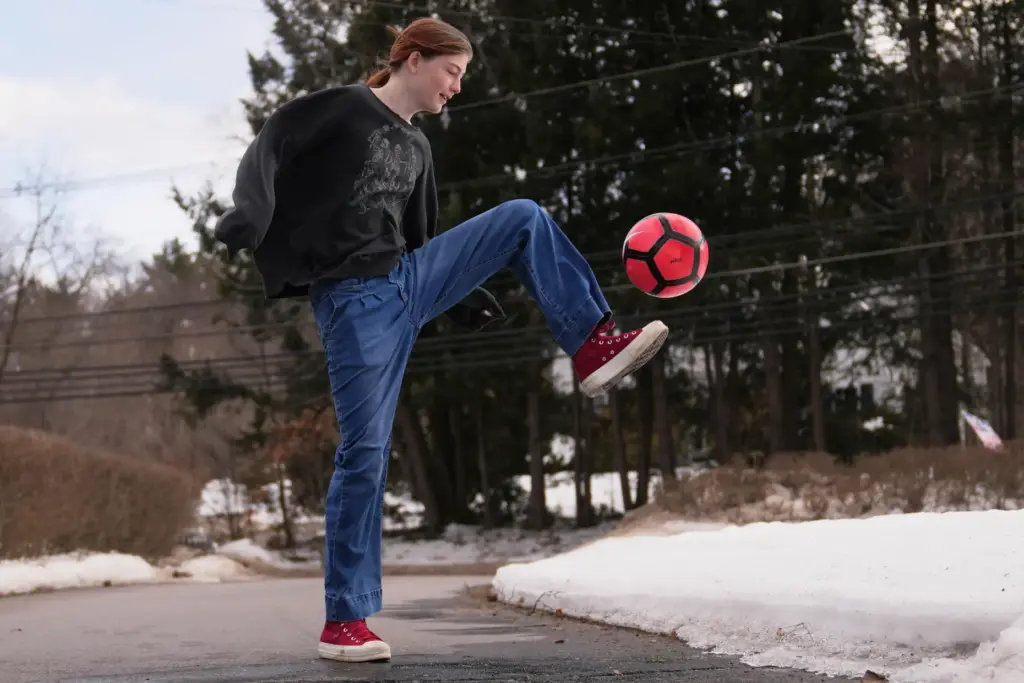 Parker Tirrell practices soccer in the driveway of her family home.