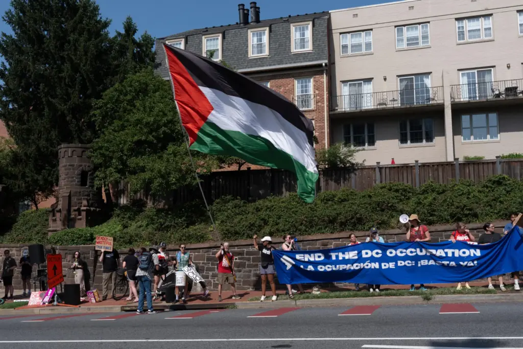 Protesters rally near a ceremony attended by Defense Secretary Pete...