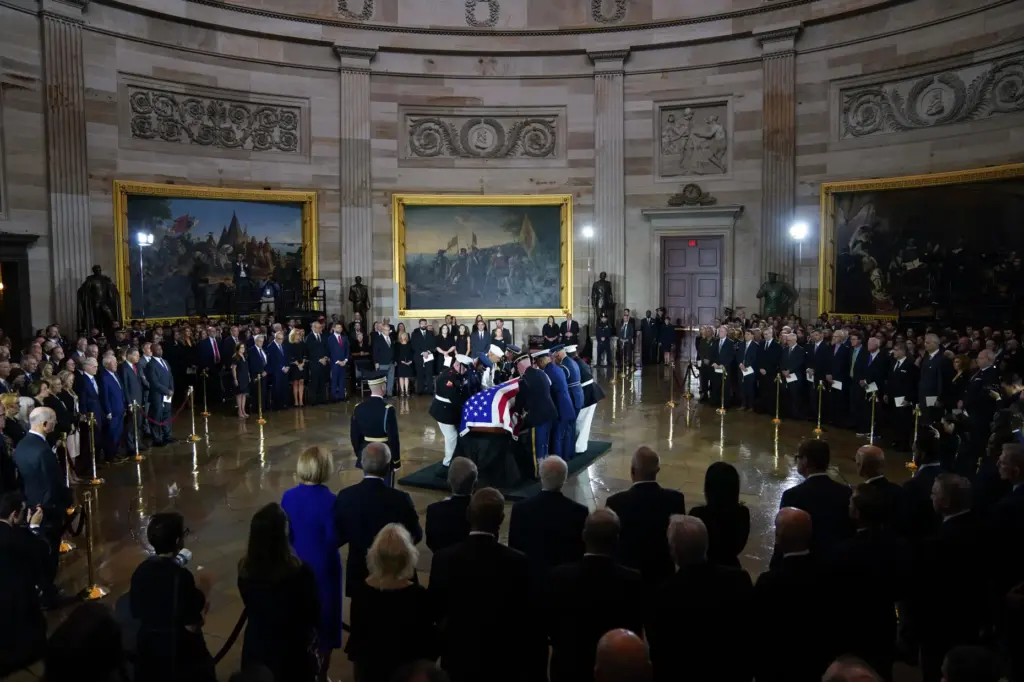 A team places the flag-draped casket of Sen. Lindsey Graham in the Capitol Rotunda.