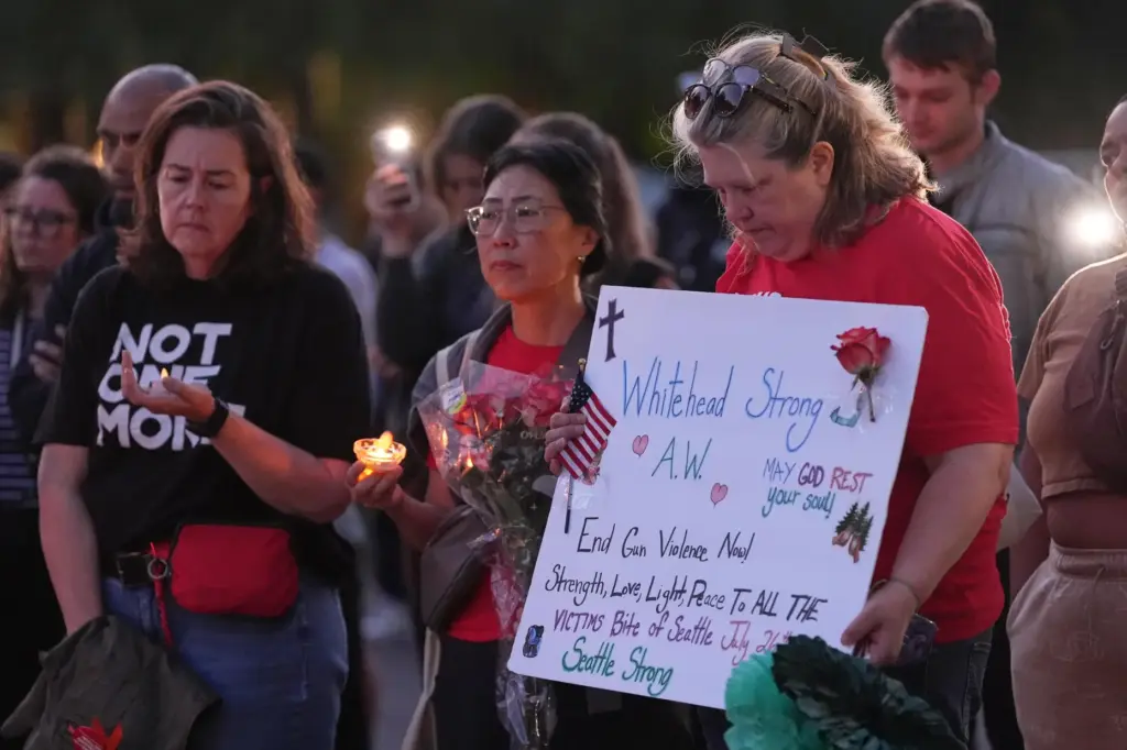Michelle Whitehead. cousin of victim Ashley Whitehead, attends a vigil.