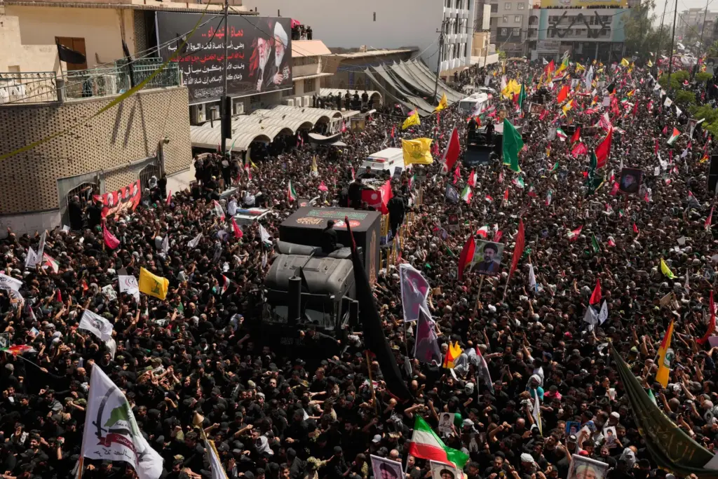 A truck carries the coffin of the Iranian Supreme Leader Ayatollah Ali Khamenei among mourners.