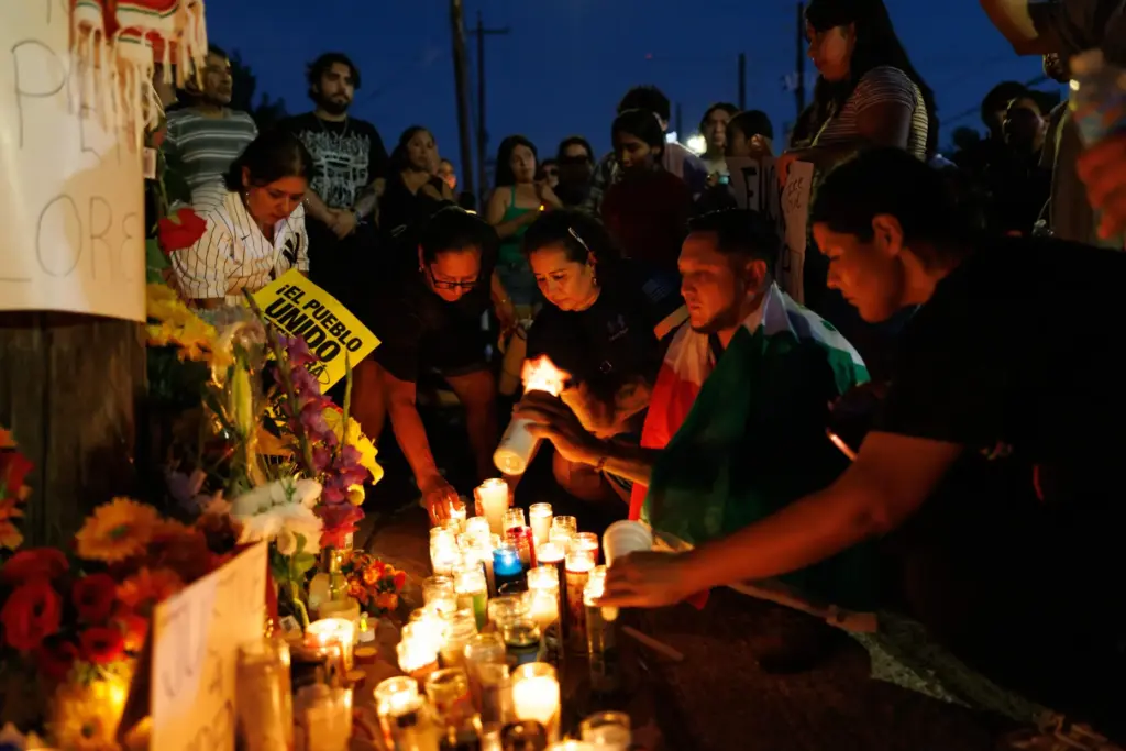Attendees light candles during a vigil for Lorenzo Salgado Araujo,...