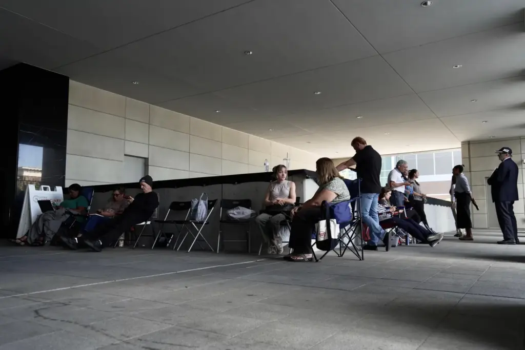 A line forms for people looking to access limited public...