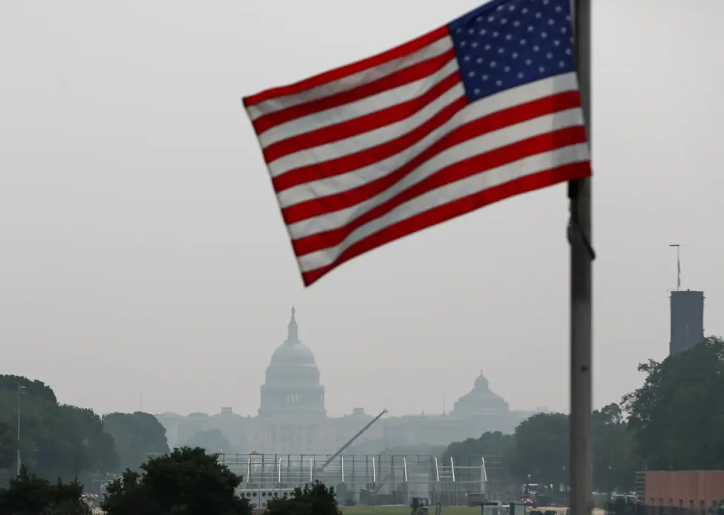 The U.S. Capitol is seen, as smoke from wildfires blankets...