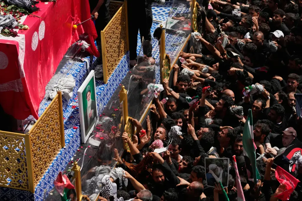 Mourners reach toward a truck carrying the coffin of Iranian Supreme Leader Ayatollah Ali Khamenei.