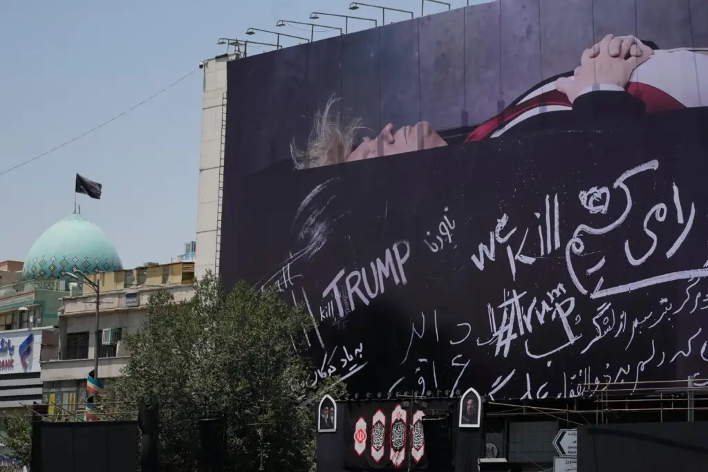 A billboard depicting President Donald Trump lying on what appears to be a coffin.